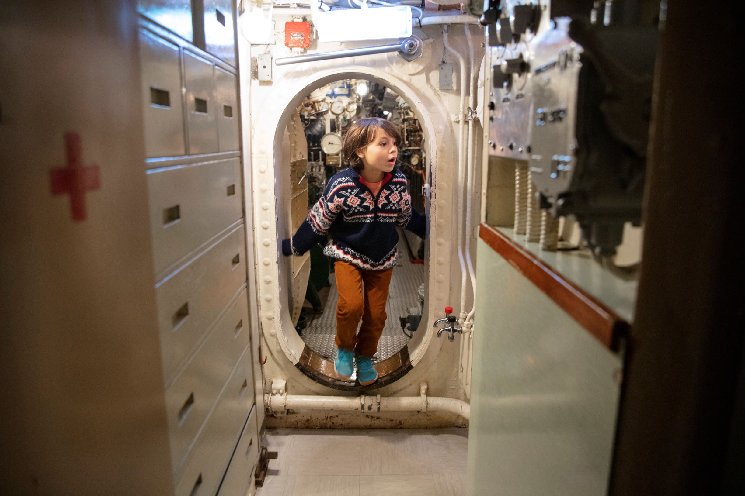 A child explores HMS Alliance at the Royal Submarine Museum